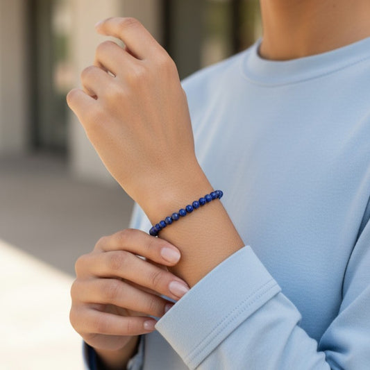 Model wearing handmade natural Lapis Lazuli beaded bracelet, 4mm beads with a pale blue top.