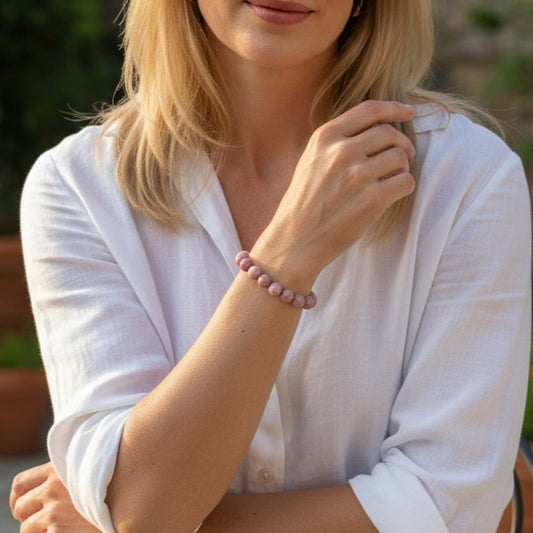 Model wearing handmade natural Rhodnite beaded bracelet, 8mm beads and a white shirt.
