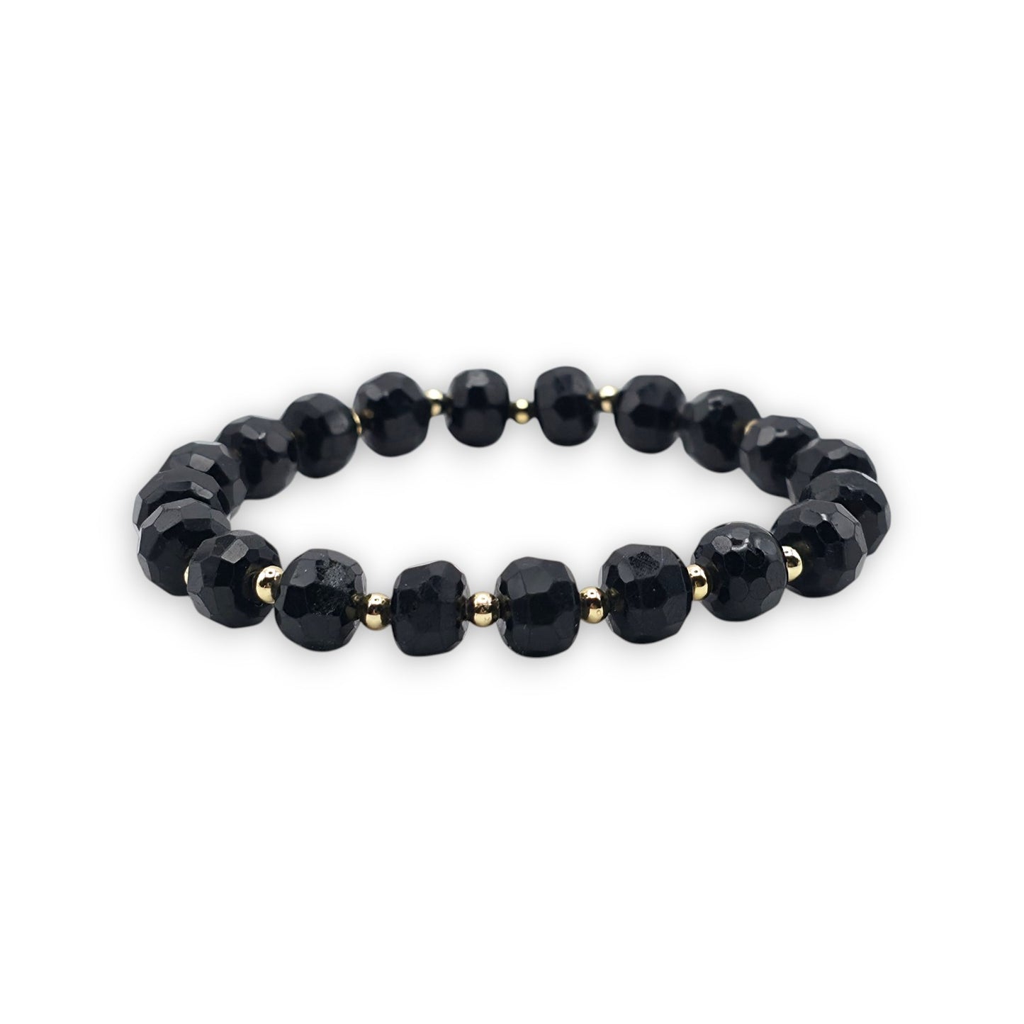 A beaded stretch bracelet featuring faceted Black Tourmaline beads separated by small gold spacer beads, shown against a plain white background.