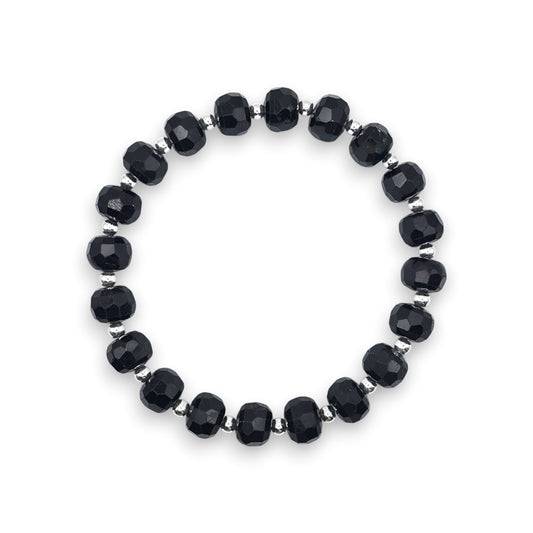 A beaded stretch bracelet featuring faceted Black Tourmaline beads separated by small silver spacer beads, displayed on a clean white background.