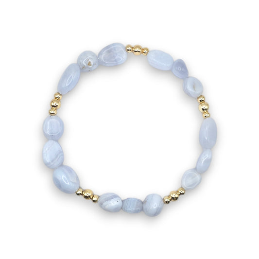 A beaded stretch bracelet featuring Blue Lace Agate nugget beads and small gold spacer beads, displayed on a clean white background.