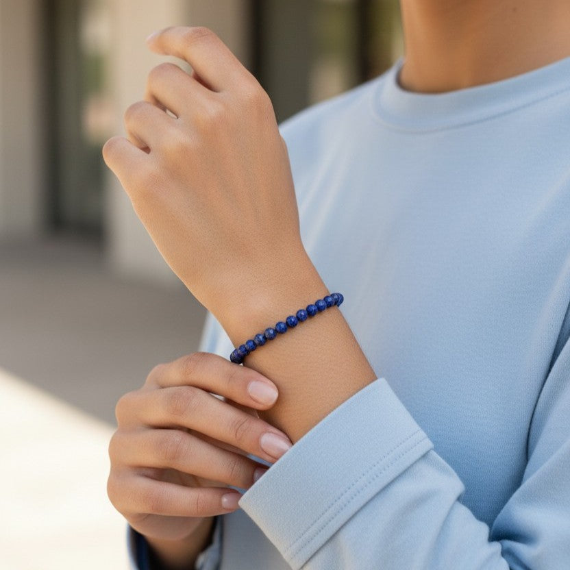 Model wearing handmade natural Lapis Lazuli beaded bracelet, 4mm beads with a pale blue top.