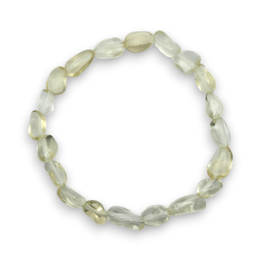 A beaded stretch bracelet made of faceted, irregular pale yellow-green gemstone beads, arranged in a circular shape on a clean white background.