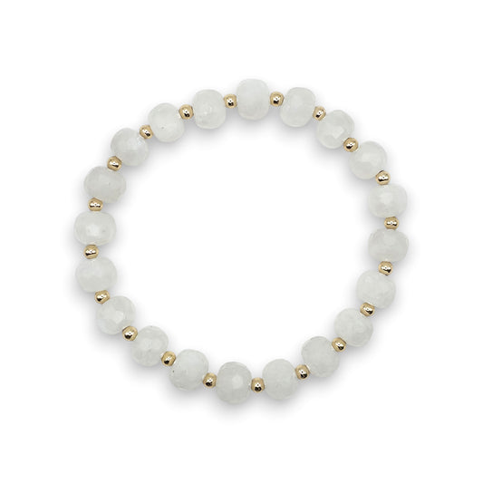 A beaded stretch bracelet featuring faceted, round white Moonstone beads separated by small gold spacer beads, shown against a plain white background.