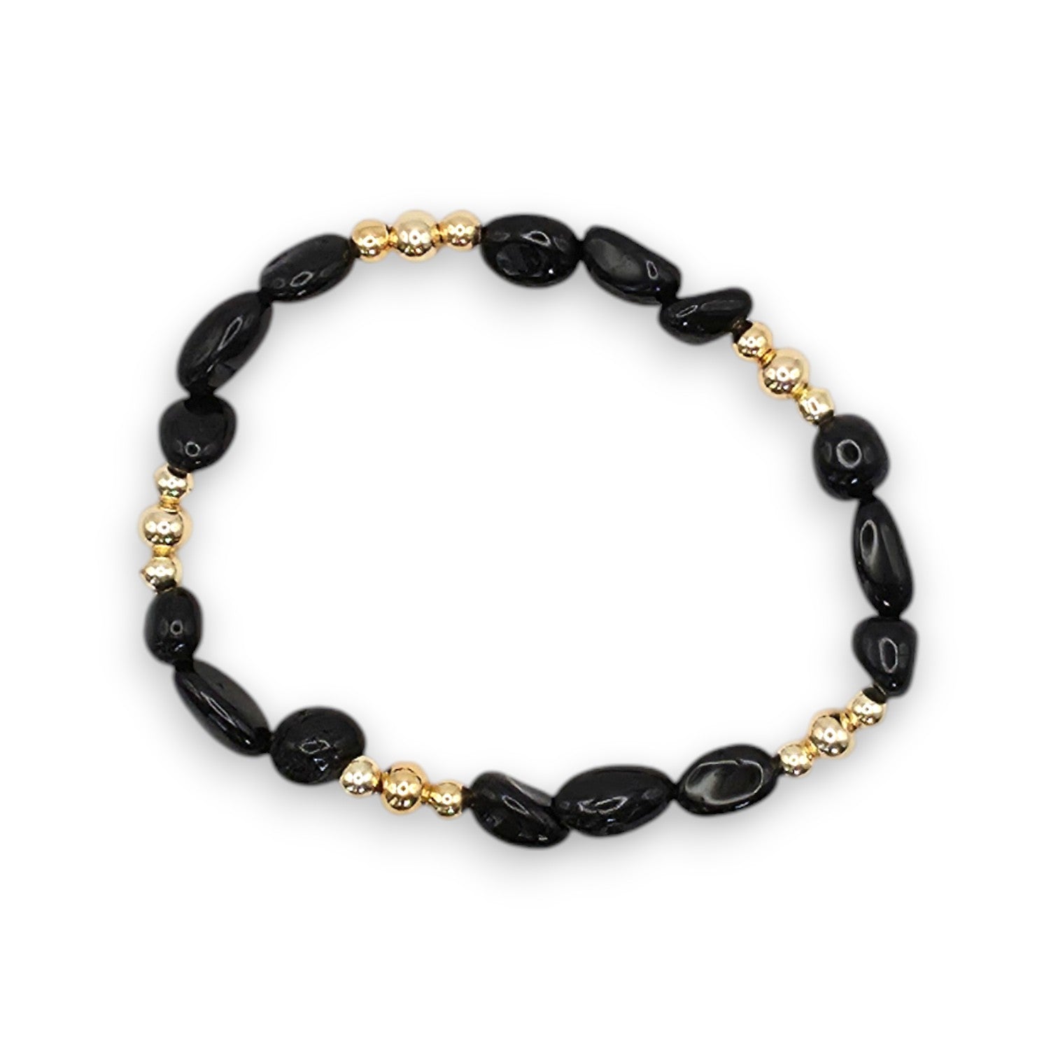 A beaded stretch bracelet featuring polished black onyx nugget beads and small metallic gold spacer beads, displayed on a clean white background.