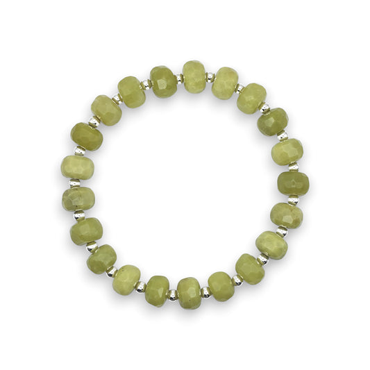 A beaded stretch bracelet featuring faceted green Serpentine beads separated by small silver metallic spacers, displayed on a clean white background.